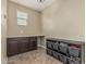Walk-in closet with brown cabinets and gray storage baskets for optimal organization at 1915 S Ponderosa Dr, Gilbert, AZ 85295