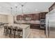 Kitchen featuring a large center island, granite countertops, stainless appliances and dark cabinets at 1915 S Ponderosa Dr, Gilbert, AZ 85295