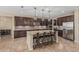 A gourmet kitchen featuring a large island, granite counters, stainless steel appliances, and stylish pendant lighting at 1915 S Ponderosa Dr, Gilbert, AZ 85295