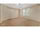 Spacious living room with carpet flooring, ample natural light, and a stylish tray ceiling with light fixture at 1915 S Ponderosa Dr, Gilbert, AZ 85295