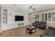 Relaxing living room features a wall unit, ceiling fan, and plantation shutters, providing comfort and style at 1915 S Ponderosa Dr, Gilbert, AZ 85295