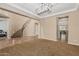 Open-concept living space with a curved staircase and tile flooring, perfect for modern living at 1915 S Ponderosa Dr, Gilbert, AZ 85295