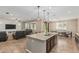 Open concept living area with kitchen island, dining space, and living room, perfect for entertaining at 1915 S Ponderosa Dr, Gilbert, AZ 85295
