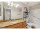 Well-lit bathroom featuring granite counters, cabinets, mirror and a bathtub with shower at 2025 E Campbell Ave # 107, Phoenix, AZ 85016