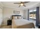 Stylish bedroom with a ceiling fan, cozy bed, window, and side tables for a relaxing retreat at 2025 E Campbell Ave # 107, Phoenix, AZ 85016
