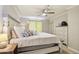 Cozy bedroom featuring a ceiling fan and a comfortable bed adorned with pillows and dresser at 2025 E Campbell Ave # 107, Phoenix, AZ 85016