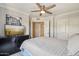 Charming bedroom featuring a ceiling fan, neutral walls, and a cozy bed with dresser and lighting at 2025 E Campbell Ave # 107, Phoenix, AZ 85016