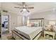 Cozy bedroom featuring a ceiling fan, neutral walls, and a comfortable bed with decorative pillows and side table at 2025 E Campbell Ave # 107, Phoenix, AZ 85016