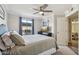 Stylish bedroom featuring a ceiling fan, comfortable bed, and neutral walls with a door at 2025 E Campbell Ave # 107, Phoenix, AZ 85016