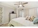 Bright bedroom with a ceiling fan, dresser and a comfy bed adorned with pillows and neutral walls at 2025 E Campbell Ave # 107, Phoenix, AZ 85016