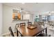 Open dining area with wood table, bar seating, and a view into the adjacent living spaces at 2025 E Campbell Ave # 107, Phoenix, AZ 85016