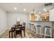 Well-lit dining area with wood flooring, table, and barstool seating that adjoins to kitchen at 2025 E Campbell Ave # 107, Phoenix, AZ 85016