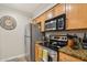 Modern kitchen with stainless steel appliances, ample cabinetry, and stylish countertops with cooking essentials at 2025 E Campbell Ave # 107, Phoenix, AZ 85016