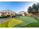 Lush backyard features a manicured lawn and putting green at 21084 E Cherrywood Dr, Queen Creek, AZ 85142