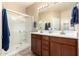Bathroom featuring double sinks and a glass enclosed walk-in shower at 21084 E Cherrywood Dr, Queen Creek, AZ 85142
