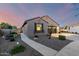 Charming single-story home features a well-manicured yard, walkway, and a two-car garage at 21084 E Cherrywood Dr, Queen Creek, AZ 85142
