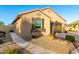 Beautiful single-story home with a tidy front yard, gravel landscaping, and a charming window box at 21084 E Cherrywood Dr, Queen Creek, AZ 85142