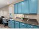 A work station near the kitchen featuring blue cabinets and countertop space at 21084 E Cherrywood Dr, Queen Creek, AZ 85142