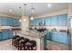 This kitchen features blue cabinetry, a granite island with seating, and stainless steel appliances at 21084 E Cherrywood Dr, Queen Creek, AZ 85142