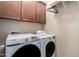 Functional laundry room with a stacked washer and dryer at 21084 E Cherrywood Dr, Queen Creek, AZ 85142