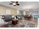 Spacious living area with blue-toned kitchen cabinets, a sectional sofa, and a dining table at 21084 E Cherrywood Dr, Queen Creek, AZ 85142