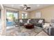 Comfortable living room with a large sectional sofa, stylish rug, and sliding doors to the backyard at 21084 E Cherrywood Dr, Queen Creek, AZ 85142