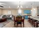 Inviting living area featuring an open floor plan, blue cabinets, and a dining set at 21084 E Cherrywood Dr, Queen Creek, AZ 85142