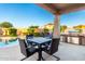 Inviting outdoor dining area featuring a built-in grill and covered seating, perfect for entertaining at 21084 E Cherrywood Dr, Queen Creek, AZ 85142