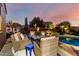 Relaxing backyard area by the pool includes comfortable seating, desert landscaping, and a peaceful ambiance at 21084 E Cherrywood Dr, Queen Creek, AZ 85142