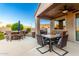 Cozy outdoor patio with ceiling fan, dining table, grill, and a sliding glass door at 21084 E Cherrywood Dr, Queen Creek, AZ 85142