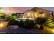 Tranquil pool and patio area with lush desert landscaping, perfect for relaxing and entertaining at 21084 E Cherrywood Dr, Queen Creek, AZ 85142