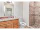 Tiled bathroom featuring a toilet, shower, vanity, and large mirror at 2114 N 69Th Pl, Scottsdale, AZ 85257