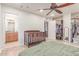 Bedroom with an ensuite bathroom, walk-in closet, ceiling fan, and crib at 2114 N 69Th Pl, Scottsdale, AZ 85257