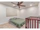 Neutral bedroom with a ceiling fan, window with blinds, and a crib in the foreground at 2114 N 69Th Pl, Scottsdale, AZ 85257