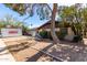 Charming single-story home with a decorative fountain and mature trees in the front yard at 2114 N 69Th Pl, Scottsdale, AZ 85257
