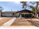 Inviting single-Gathering home featuring a decorative fountain, mature landscaping, and a two-car garage at 2114 N 69Th Pl, Scottsdale, AZ 85257