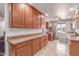 Well-lit kitchen with ample cabinet space, granite countertops, and tiled floors at 2114 N 69Th Pl, Scottsdale, AZ 85257