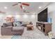 Open-concept living room featuring recessed lighting, a sectional couch, and a large screen TV at 2114 N 69Th Pl, Scottsdale, AZ 85257