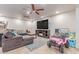 Spacious living room with tile flooring, ceiling fans, and a large sectional sofa at 2114 N 69Th Pl, Scottsdale, AZ 85257