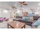 Comfortable living area featuring a sectional sofa, area rug, and a view into the kitchen at 2114 N 69Th Pl, Scottsdale, AZ 85257