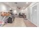 Functional office room with double doors, tile floors, and multiple computer setups at 2114 N 69Th Pl, Scottsdale, AZ 85257