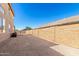 A low-maintenance backyard with gravel ground cover, perfect for outdoor entertaining and relaxation at 2152 W Sunshine Butte Dr, San Tan Valley, AZ 85144