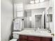 Bright bathroom with a spacious countertop, big mirror, and a glass shower at 2152 W Sunshine Butte Dr, San Tan Valley, AZ 85144