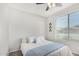 Bright bedroom with queen bed, soft blue accents, and lots of natural light at 2152 W Sunshine Butte Dr, San Tan Valley, AZ 85144