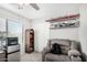 Bedroom with chair, bookshelf, mini fridge, and shelving for decor at 2152 W Sunshine Butte Dr, San Tan Valley, AZ 85144