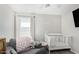 Charming Bedroom featuring crib, chair, and personalized 'Jane Lloyd' wall decor at 2152 W Sunshine Butte Dr, San Tan Valley, AZ 85144