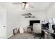 Bedroom featuring a ceiling fan, neutral walls, and a desk with shelving for decor at 2152 W Sunshine Butte Dr, San Tan Valley, AZ 85144