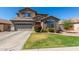 Beautiful two-story home with landscaped front yard and attached two-car garage at 2152 W Sunshine Butte Dr, San Tan Valley, AZ 85144