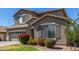 Charming two-story home featuring shutters, a well-maintained lawn, and beautiful landscaping at 2152 W Sunshine Butte Dr, San Tan Valley, AZ 85144
