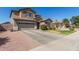 Charming two-story home with attached garage, rock landscaping, and grass at 2152 W Sunshine Butte Dr, San Tan Valley, AZ 85144